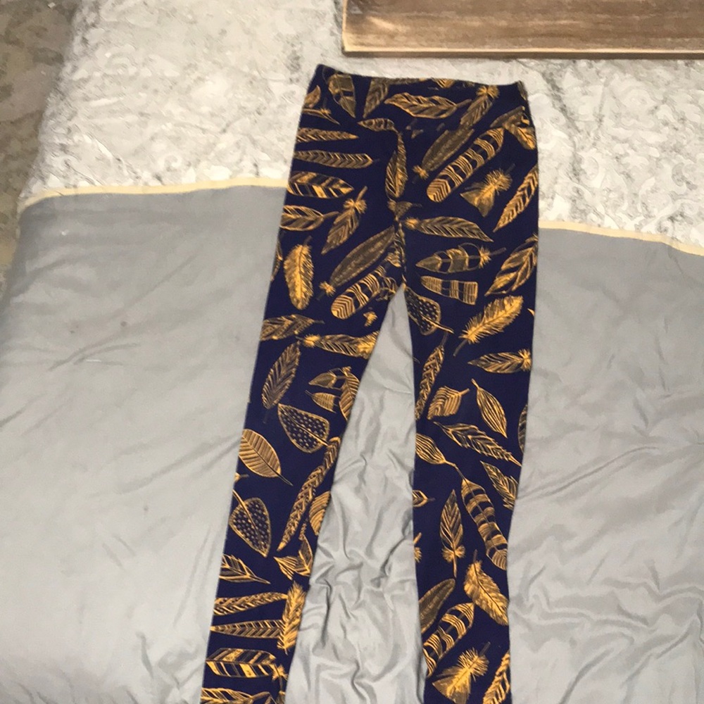 Lula roe one size fits all leggings, purple with feathers on it .